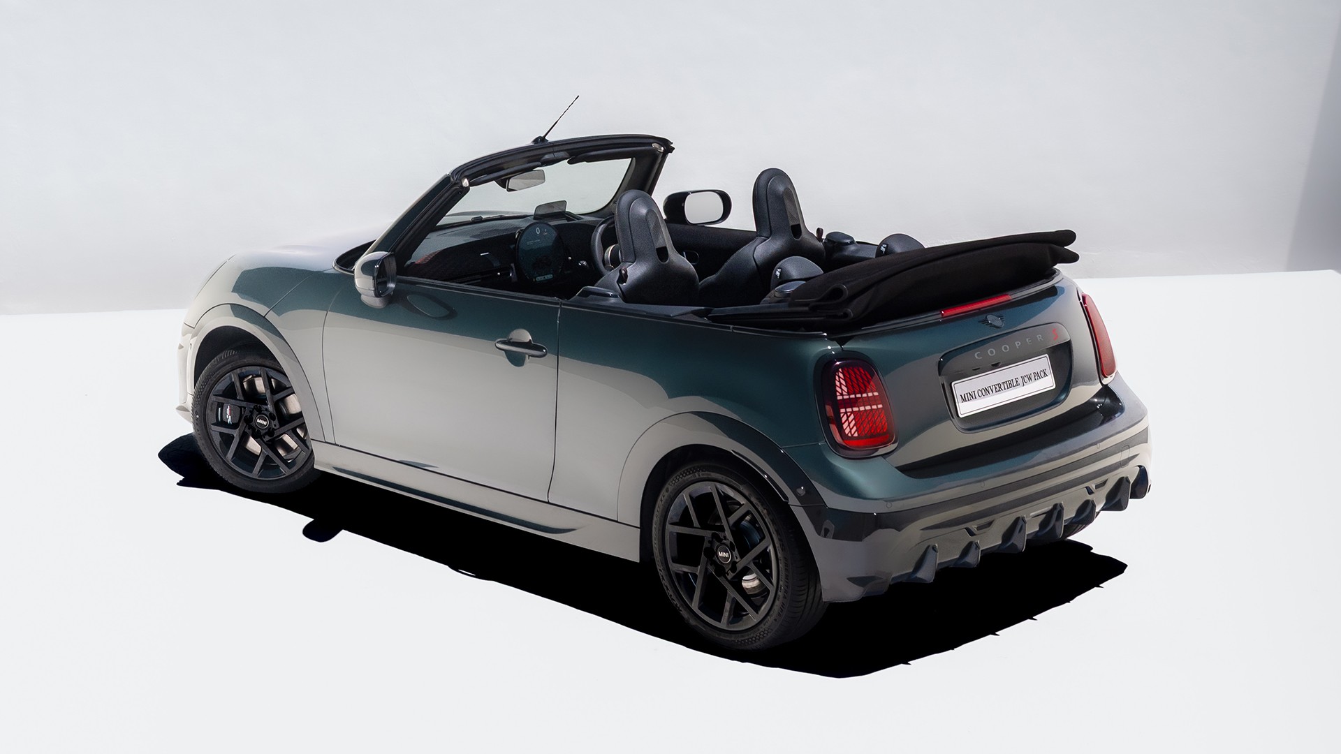 Rear view of a driving MINI Cooper Convertible in Copper Grey 